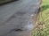 Road damage on Back Lane where previously patched
